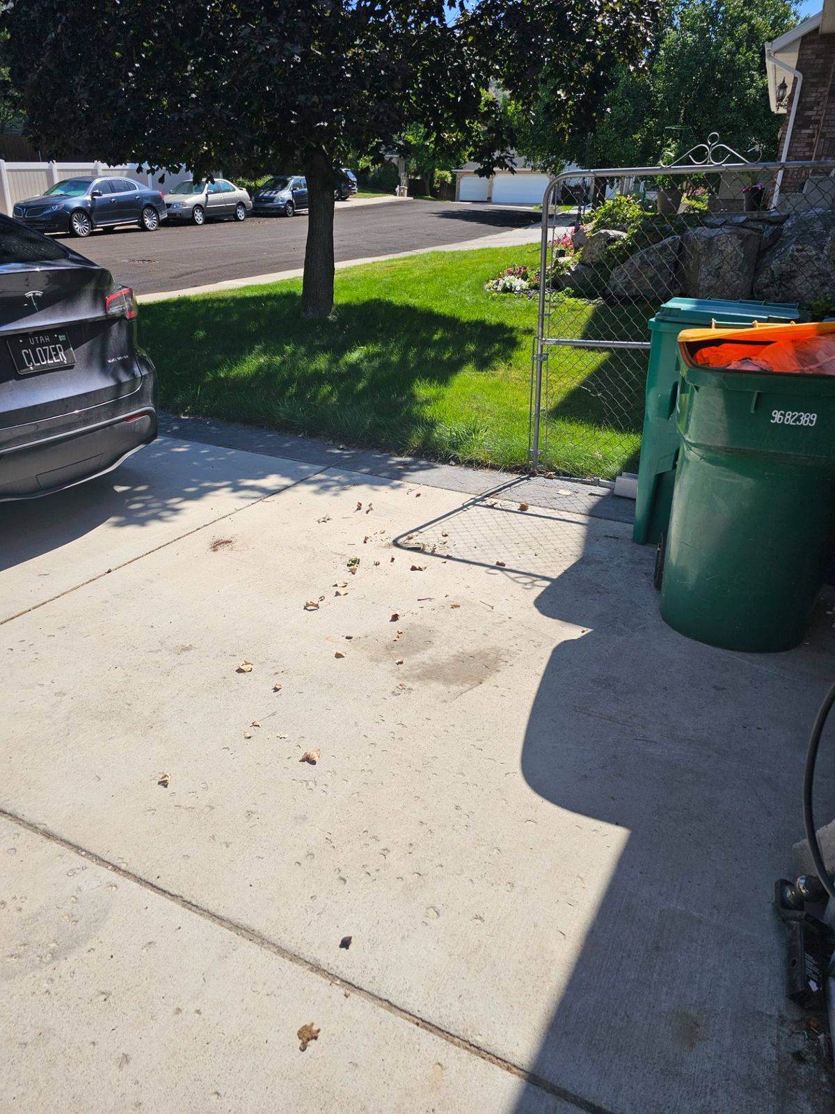 Cleared concrete driveway beside bins after a Dragon’s Haul Away pickup